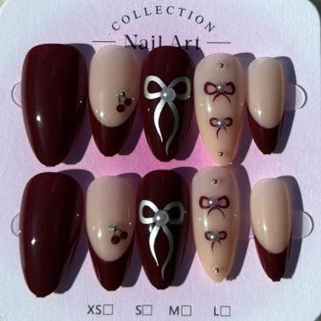 Burgundy nails with a silver bow, cherries and pearls